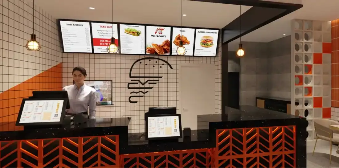 The Wingify counter — menu boards overhead and the orange herringbone front